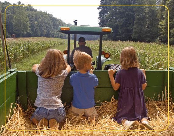 children on hay bale ride at agritourism concessions event